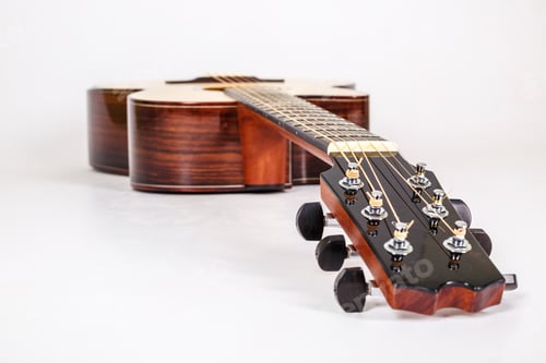 Preview: Tuning pegs on wooden machine head of six strings guitar on white background