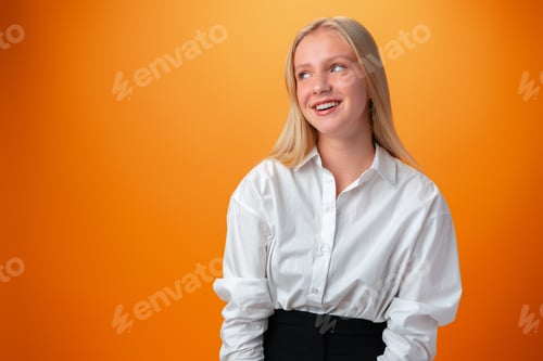 Preview: Portrait of smiling young teen girl against orange background