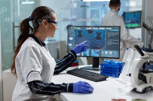 Preview: Scientist biologist researcher woman looking at coronavirus expertise on computer