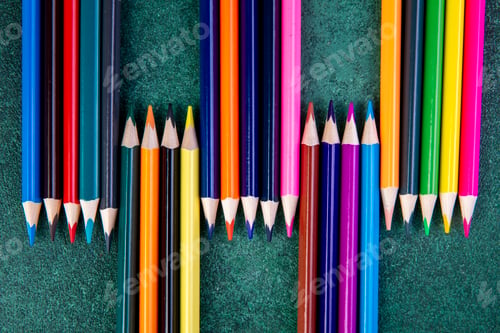 Preview: top view color pencils on green background