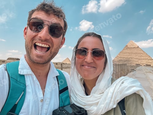 Preview: Tourists smiling at giza pyramid complex in egypt