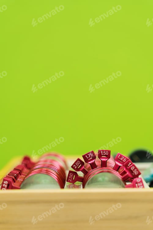 Preview: Eye exam set of trial frame lenses on green background for short or long sight correction