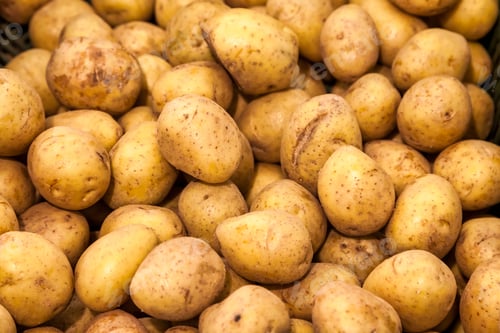 Preview: Close up view of many fresh potatoes filling entire space