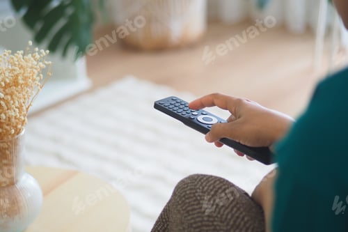 Preview: Enjoying a relaxing evening at home with a remote control