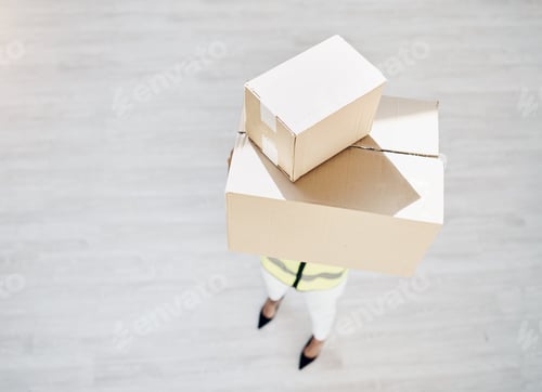 Preview: Are you expecting a delivery. High angle shot of a young woman holding boxes for delivery.