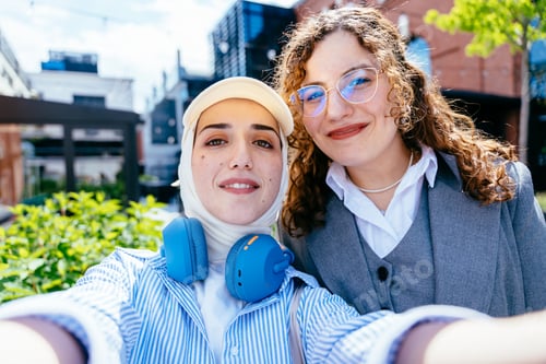 Preview: Two women taking selfie outdoors in city area