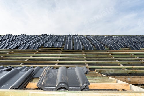 Preview: Roof ceramic tile arranged in packets on the roof on roof battens. laying tiles on a boarded roof.