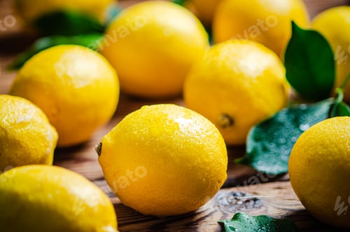 Preview: Fresh lemons. On wooden table.
