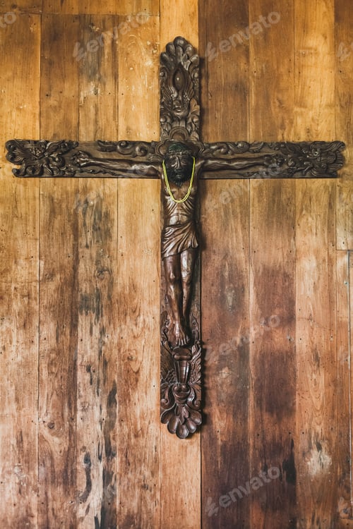Preview: Carved figure of Jesus hanging on wooden background wall