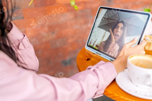 Preview: Freelancer video calling from coffee shop with tablet