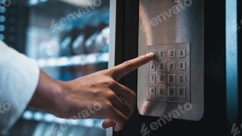 Preview: Close up hand of woman pushing button on vending machine for choosing a snack or drink.