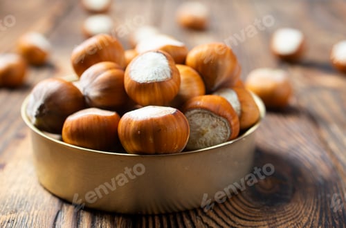Preview: Hazelnuts on wooden backdrop. heap or stack of hazelnuts. Hazelnut background, healty food