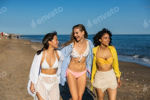 Preview: Multiethnic girlfriends walking and having fun on the beach