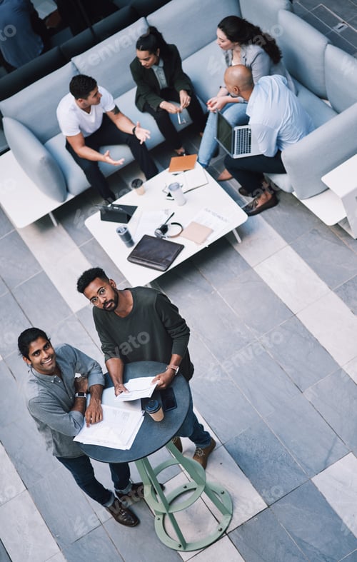Preview: High angle shot of a group of businesspeople having a meeting at a conference