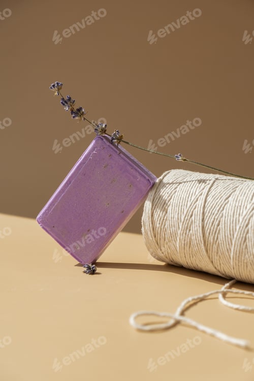Preview: Handcrafted purple lavender soap with lavender flowers and spool of white cotton rope. Natural