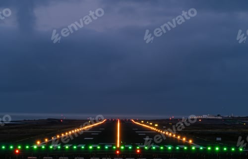 Preview: Illuminated runway at night with ocean view