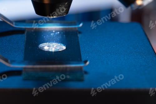 Preview: Microscope with lenses close up against dark background