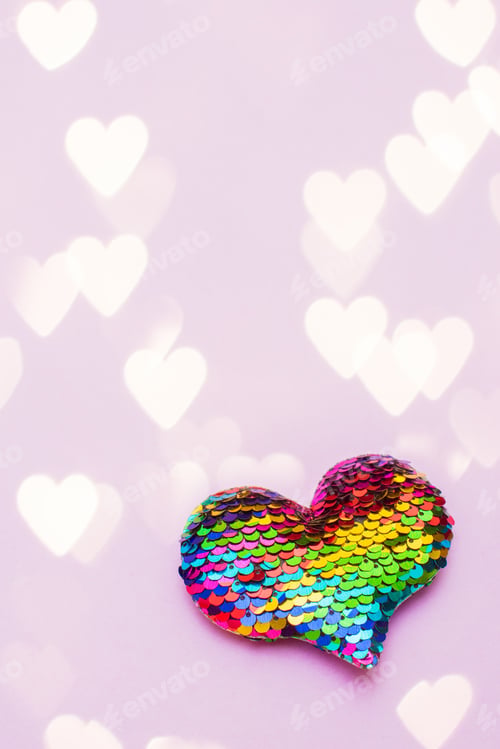 Preview: Colorful heart made of sequins on a pink background. Copy space