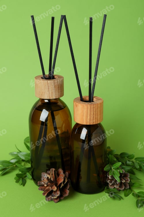 Preview: Aroma scent diffusers, cones and leaves on green background