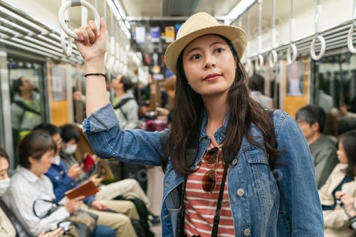 Preview: girl traveler taking Osaka subway in japan