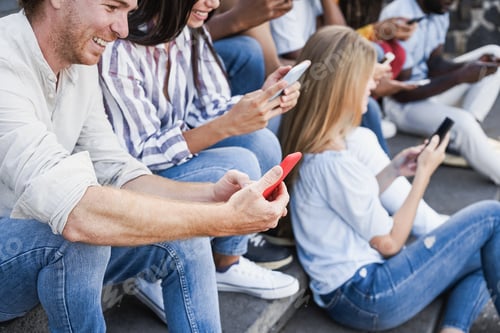 Preview: Young happy people using mobile phones outdoor in the city