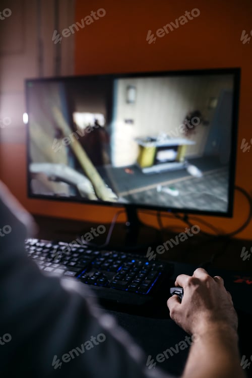 Preview: Young man sitting at his PC, playing computer games