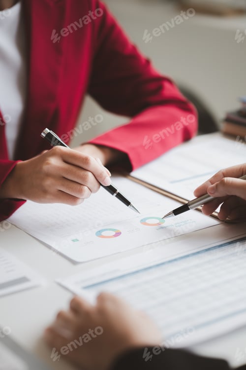Preview: Two businessmen are brainstorming together and reviewing the company financial documents that the fi