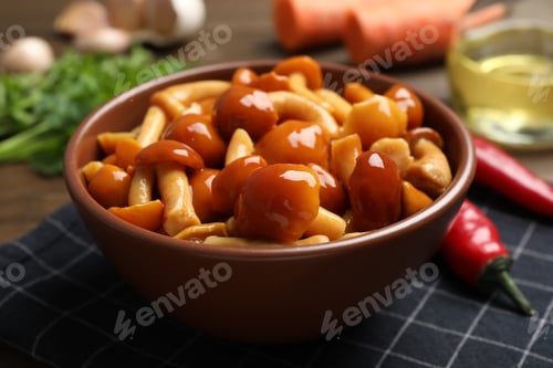 Preview: Tasty marinated mushrooms in bowl on table, closeup