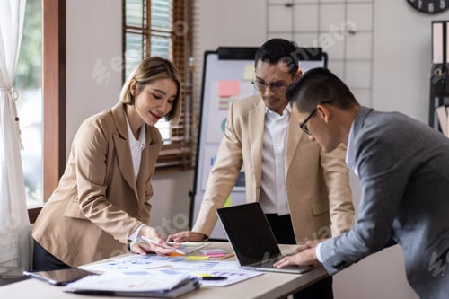 Preview: Group of confident business people point to graphs and charts to analyze market data, balance sheet,