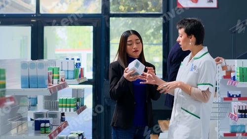 Preview: Pharmacologist assisting customer