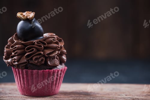 Preview: Delicious Chocolate Cupcake with Frosting and Walnut Topping