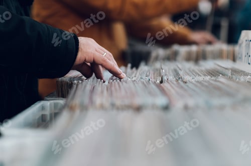 Preview: Man hands browsing vinyl album in a record store