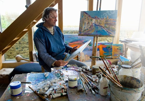 Preview: Portrait of artist examining painted canvas in studio