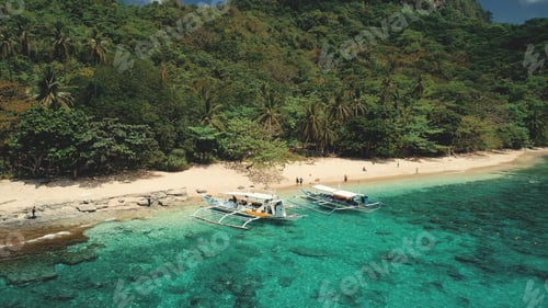 Preview: Cliff shore, passenger boats on ocean bay parallax aerial view. Green tropic forest on rocky shore