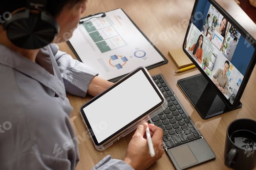 Preview: asisn woman video conference busienss meeting with colleage online with tablet at home