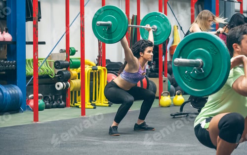 Preview: Woman practicing weightlifting in the gym