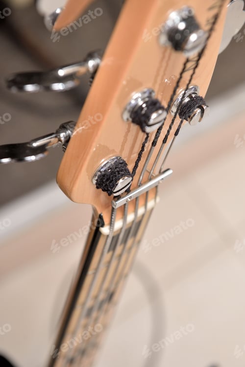 Preview: Vertical shot of strings of a guitar on a blurred background