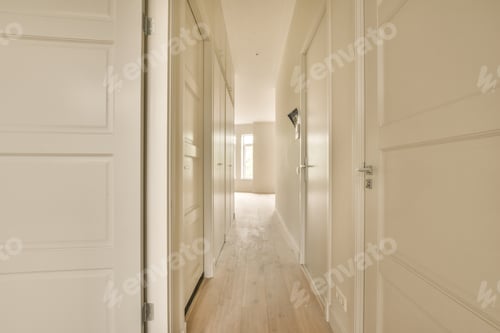 Preview: a hallway with white wood floors and white doors