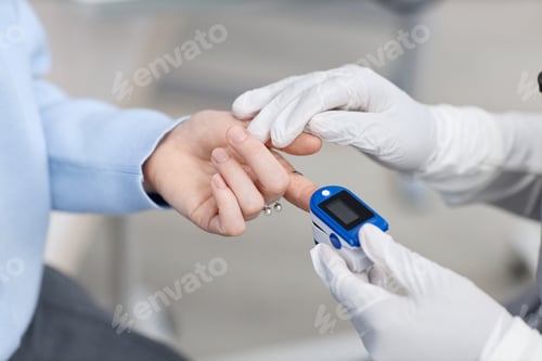 Preview: Caucasian Young Adult Woman Having Oxygen Level Measured with Pulse Oximeter