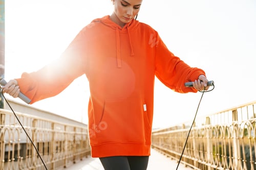 Preview: Woman outdoors make exercise with skipping jumping rope.