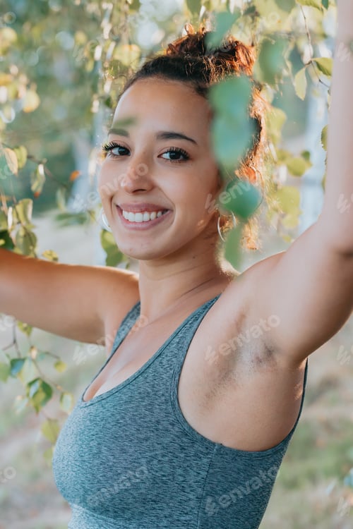 Preview: Close portrait of a smiling young african arab poc happy after finishing her training. New habits