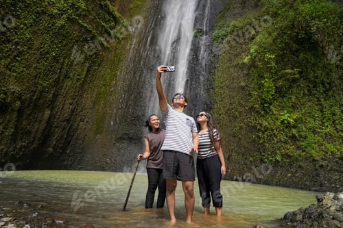 Preview: small group of young asian indonesian man and woman taking selfie photos