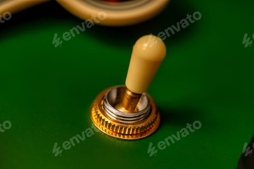 Preview: Closeup of a vibrant green electric guitar pickup switch