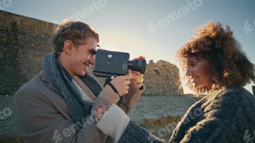 Preview: Curly lady posing photographer evening beach closeup. Blonde guy taking photos