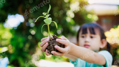 Preview: Children planting a tree for save the earth. Concept for eco gardening and sustainable living.