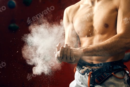 Preview: Man coating his hands in powder chalk magnesium preparing to climb, motion