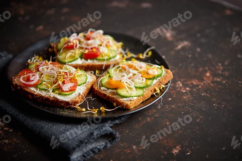 Preview: Healthy toasts with cucomber, tomatoes and crumbled feta and radish sprouts
