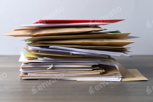Preview: Stack of different paper envelopes on wooden table, closeup. Post office