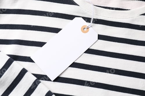 Preview: Cardboard tag on striped garment, top view
