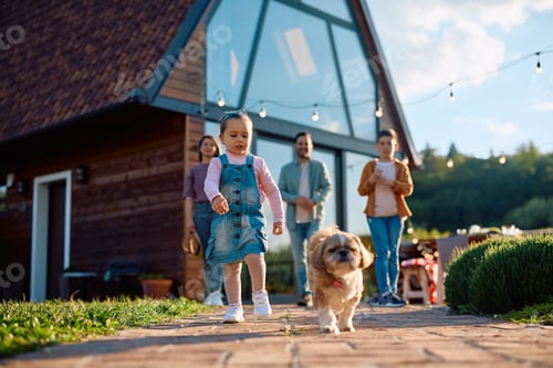 Preview: Little girl enjoying with her dog during family day outdoors.